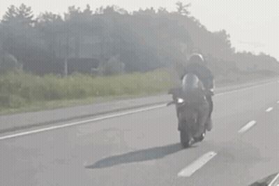 Person Riding Motorcycle On Highway GIF
