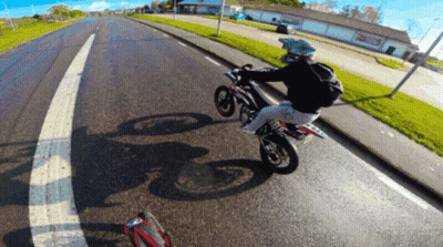 Person Riding Motorcycle Past Building Saying A & A GIF