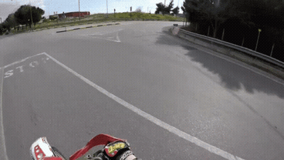 Person Riding Motorcycle Past Stop Sign GIF