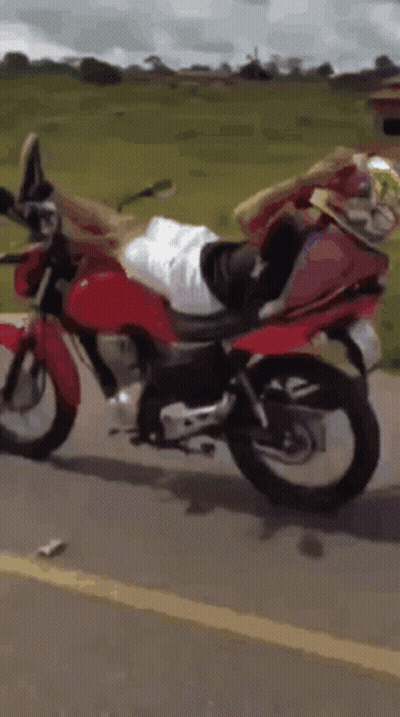 Person Riding Red Motorcycle On Road GIF
