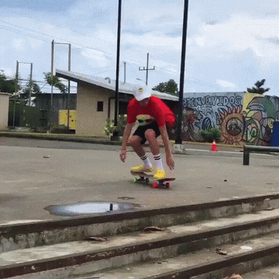 Person Riding Skateboard In Front Of Bienvenidos Mural GIF