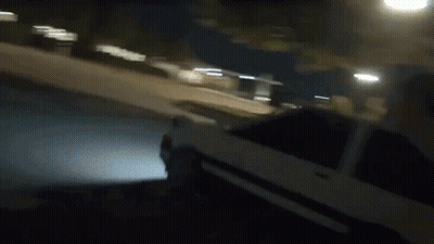 Person Riding Small Car On Sidewalk At Night GIF