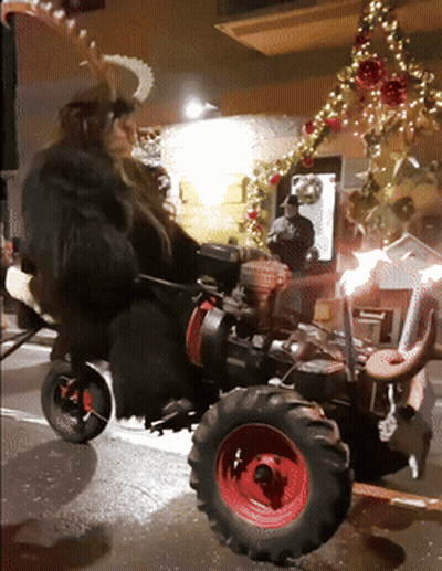 Person Riding Tractor On Street At Night GIF