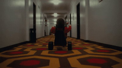 Person Riding Tricycle In Hallway GIF