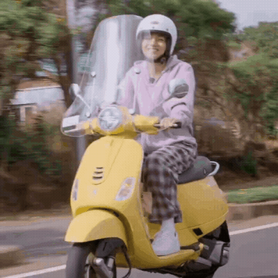 Person Riding Yellow Scooter GIF
