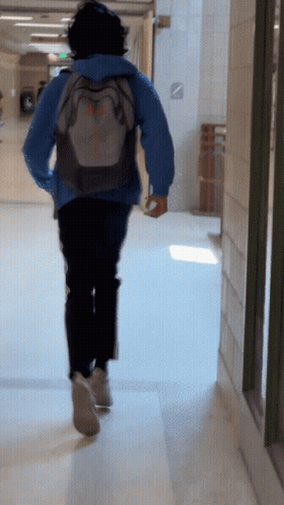 Person Running Down Hallway With Columbia Backpack GIF