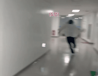Person Running Down Hallway With Eee Sign GIF