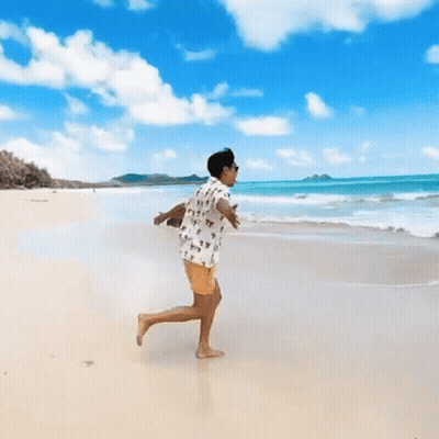 Person Running On Beach With Arms Outstretched GIF