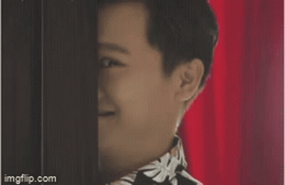 Person's Face Behind Red Curtain GIF