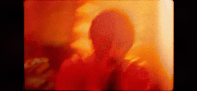 Person's Face Close Up Red Yellow Background GIF
