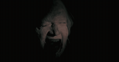 Person's Face In The Dark GIF