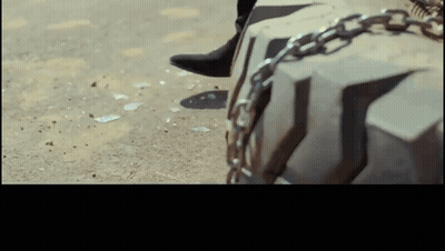 Person's Foot Chained To Tire GIF