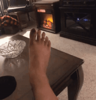 Person's Foot On Coffee Table GIF