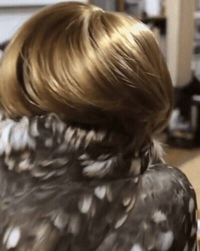 Person's Hair With Feathered Jacket GIF