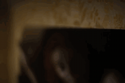 Person's Hand Holding Cell Phone In Dark GIF