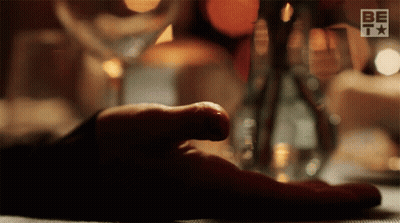 Person's Hand Rests On Table With BETV Logo GIF