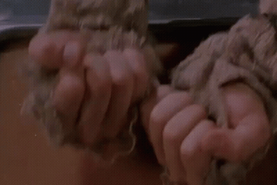 Person's Hands Tied With Blanket GIF