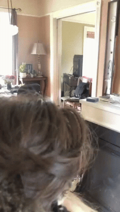 Person's Head In Living Room With Lamp GIF