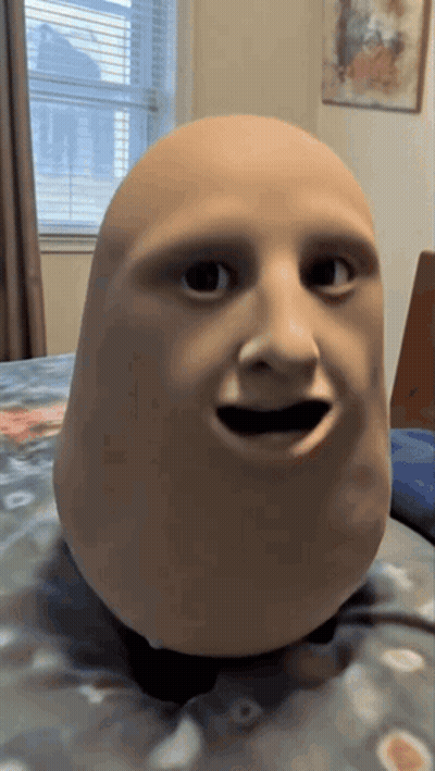 Person's Head Mask On Bed GIF