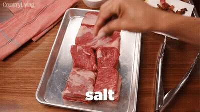 Person Salting Meat GIF