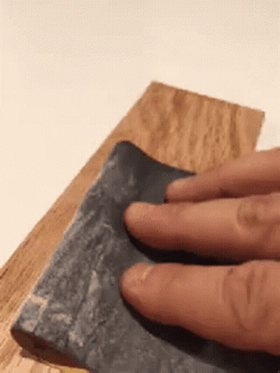 Person Sanding Wood With Fingers On Sandpaper GIF