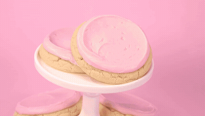 Person Scooping Ice Cream Into Cookie GIF