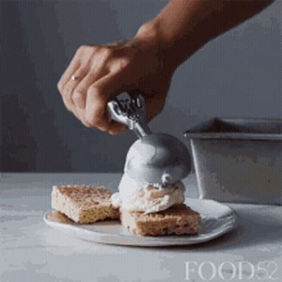 Person Scooping Ice Cream On Cake GIF