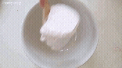 Person Scooping Strawberry Ice Cream Into Bowl GIF
