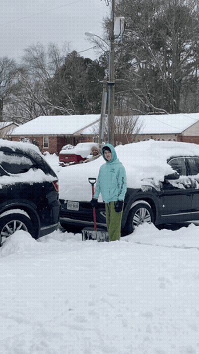 Person Shoveling Snow In Front Of Texas Car GIF