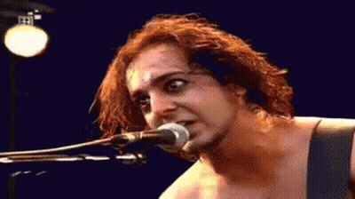 Person Singing Into Microphone Blue Background GIF