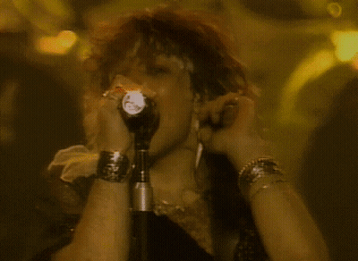 Person Singing Into Microphone With Flashlight