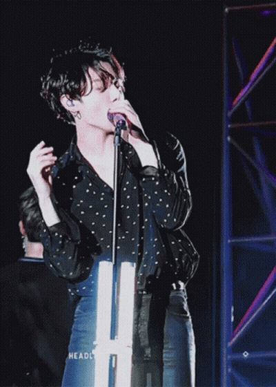 Person Singing Into Microphone With Headl GIF