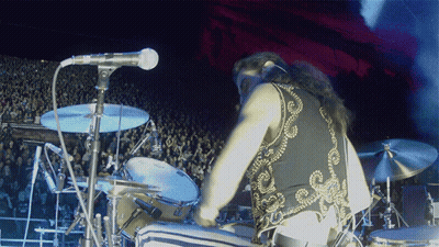 Person Singing Into Microphone With Star Shirt GIF