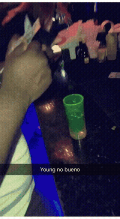 Person Sitting At Bar With Green Shot Glass GIF