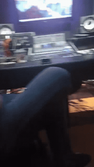 Person Sitting At Desk In Front Of TV GIF