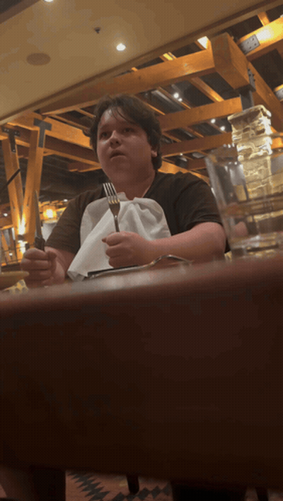 Person Sitting At Table With Fork And Knife GIF