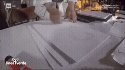 Person Sitting At Table With Papers And Microphone GIF
