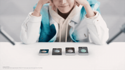 Person Sitting At Table With Row Of Phones GIF