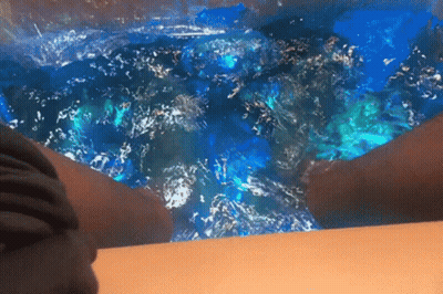 Person Sitting In Bathtub With Blue Water GIF