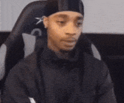 Person Sitting In Chair With Crossed Arms Making A Funny Face GIF