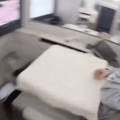 Person Sitting In Chair With White Pillow GIF
