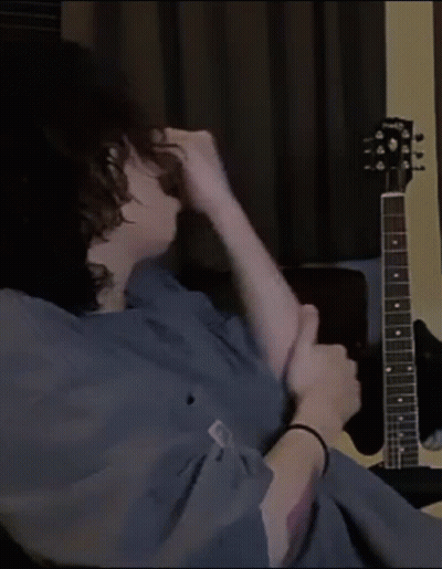 Person Sitting In Front Of Gibson Guitar GIF