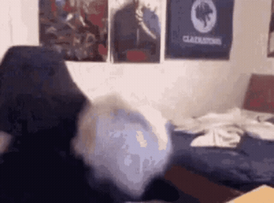 Person Sitting On Bed With Gladiator Poster GIF