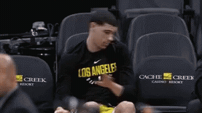 Person Sitting On Blue Ice Slope GIF