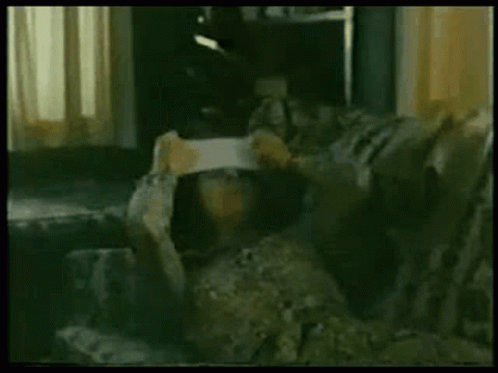 Person Sitting on Couch Holding Paper