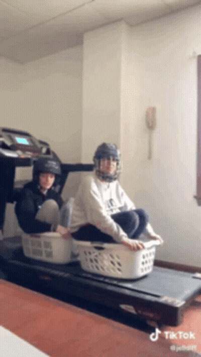 Person Sitting On Treadmill With Laundry Basket GIF