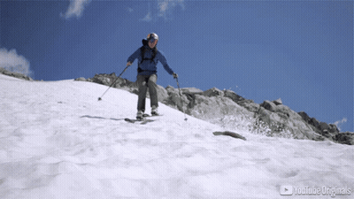 Person Skiing Down Snowy Mountain With YouTube Originals Logo GIF