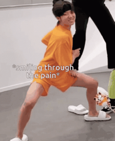 Person Smiling Through Pain Standing On One Leg GIF