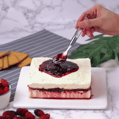 Person Spreading Berry Sauce On Cake GIF
