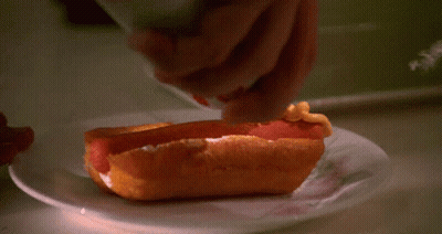Person Spreading Mustard On Hot Dog GIF